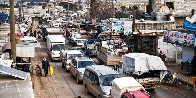 Civilians flee from Idlib toward the north to find safety inside Syria near the border with Turkey, Saturday, Feb. 15, 2020. (AP Photo)