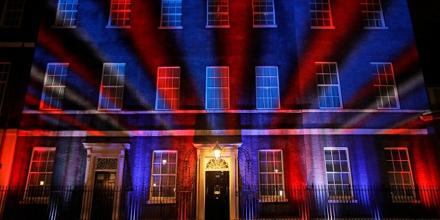 The colors of the British Union flag illuminate the exterior of 10 Downing street, the residence of the British Prime Minister, in London, England, Friday, Jan. 31, 2020. Britain officially left the European Union on Friday after a debilitating political period that has bitterly divided the nation since the 2016 Brexit referendum. (AP Photo/Kirsty Wigglesworth)