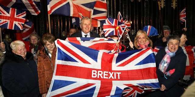 Brexit supporters celebrate during a rally outside Stormont in Belfast, Northern Ireland as Britain left the European Union on Friday, Jan. 31, 2020. Britain officially left the European Union on Friday after a debilitating political period that has bitterly divided the nation since the 2016 Brexit referendum. (AP Photo/Peter Morrison)