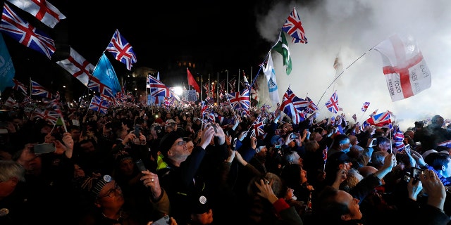 Brexit supporters celebrate during a rally in London, Friday, Jan. 31, 2020. Britain leaves the European Union after 47 years, leaping into an unknown future in historic blow to the bloc. (AP Photo/Frank Augstein)