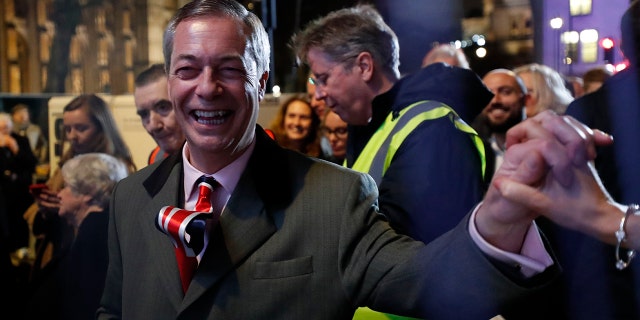 Brexit Party leader Nigel Farage shakes hands with his supporters in London, Friday, Jan. 31, 2020. The U.K. is scheduled to leave the EU at 23:00 GMT Friday, the first nation in the bloc to do so. (AP Photo/Frank Augstein)