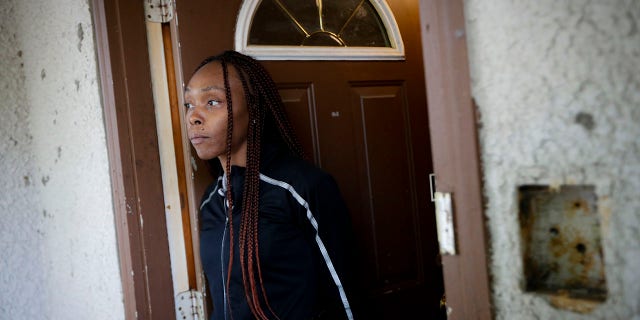 Latosha Evans, a friend of Myon Burrell who says she was with the Burrell the evening Tyesha Edwards was shot and killed at home in 2002, stands in her doorway, Wednesday, Oct. 23, 2019, in Minneapolis. (Associated Press)