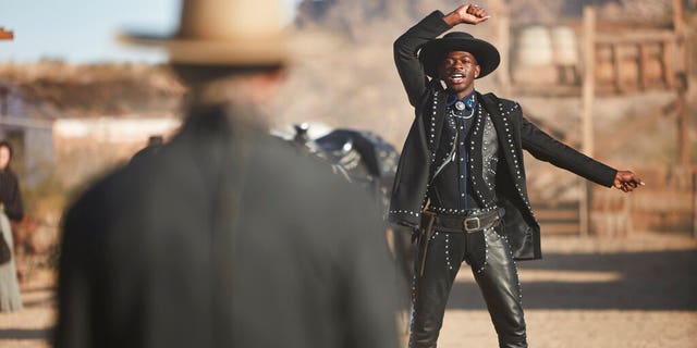 This undated photo provided by Doritos shows Lil Nas X, right, and Sam Elliott in a scene from the company's 2020 Super Bowl NFL football spot.