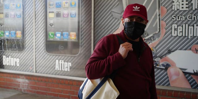 A man wears a protective mask while shopping in Alhambra, Calif., Friday, Jan. 31, 2020.