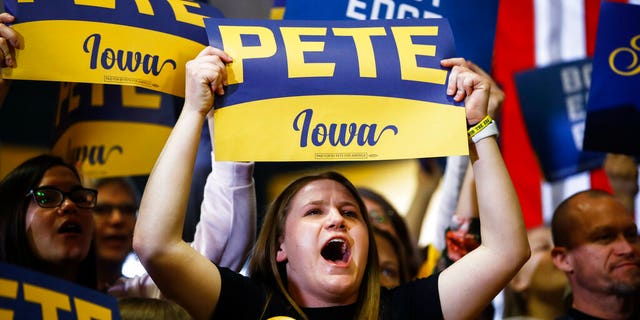 Attendees cheer as Democratic presidential candidate former South Bend, Ind., Mayor Pete Buttigieg speaks during a campaign event at Northwest Junior High, Sunday, Feb. 2, 2020, in Coralville, Iowa. (AP Photo/Matt Rourke)