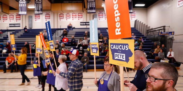 Supporters of Democratic presidential candidate former South Bend, Ind., Mayor Pete Buttigieg stand at a caucus site at Roosevelt Hight School, Monday, Feb. 3, 2020, in Des Moines, Iowa. (AP Photo/Andrew Harnik)