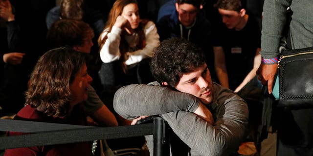 People wait for results at a caucus night campaign rally for democratic presidential candidate former Vice President Joe Biden on Monday, Feb. 3, 2020, in Des Moines, Iowa. (AP Photo/John Locher)