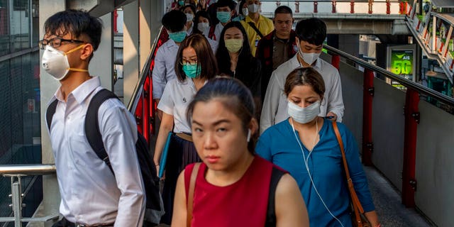 Commuters wear face masks to protect themselves from air pollution and new virus in Bangkok, Thailand, Tuesday, Feb. 4, 2020. 