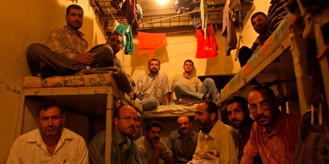 FILE - This Aug. 3, 2005 file photo, Lebanese ex-inmates of the notorious Khiam prison sit in their former cells where they displayed their belongings during a sit-in at the Khiam prison, in southern Lebanon.(AP Photo/Mohammad Zaatari, File)