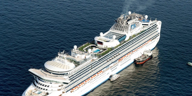 Cruise ship Diamond Princess is anchored off the shore of Yokohama, south of Tokyo, Wednesday, Feb. 5, 2020. Japan said Wednesday 10 people on the cruise ship have tested positive for a new virus and were being taken to hospitals.  (Hiroko Harima/Kyodo News via AP)
