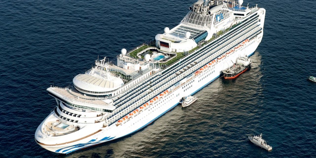 Cruise ship Diamond Princess is anchored off the shore of Yokohama, south of Tokyo, Wednesday, Feb. 5, 2020. Japan said Wednesday 10 people on the cruise ship have tested positive for a new virus and were being taken to hospitals.  (Hiroko Harima/Kyodo News via AP)