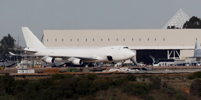 A plane carrying evacuees from the virus zone in China arrives at Marine Corps Air Station Miramar Wednesday, Feb. 5, 2020, in San Diego. (AP Photo/Gregory Bull)