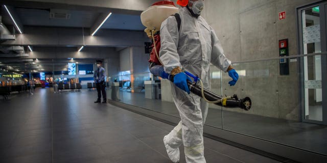 Disinfection equipment is carried by a worker as precautionary measures against the spreading of novel coronavirus, at Budapest Liszt Ferenc International Airport in Budapest, Hungary, Wednesday, Feb. 5, 2020. (Zoltan Balogh/MTI via AP)