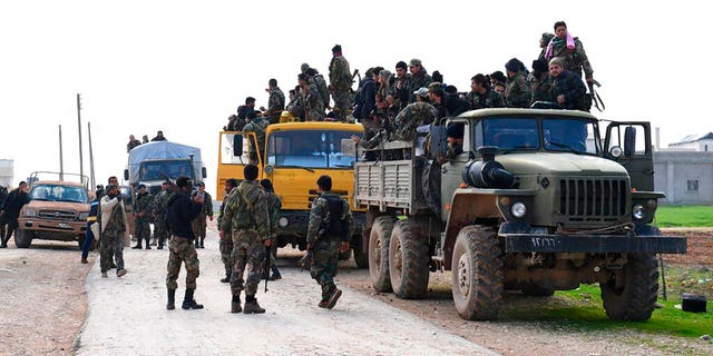 In this photo released Feb. 5, 2020 by the Syrian official news agency SANA, shows Syrian government forces entering the village of Tel-Sultan, in Idlib province, northwest Syria. (SANA via AP)