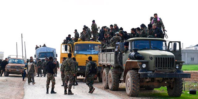 In this photo released Feb. 5, 2020 by the Syrian official news agency SANA, shows Syrian government forces entering the village of Tel-Sultan, in Idlib province, northwest Syria. (SANA via AP)