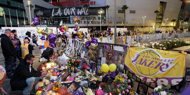 Fans gathered at a memorial for Kobe Bryant in front of Staples Center in Los Angeles following his death. (AP Photo/Damian Dovarganes, File)