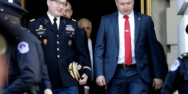 Lt. Col. Alexander Vindman, left, walks with his twin brother, Army Lt. Col. Yevgeny Vindman, in November 2019 after testifying before the House Intelligence Committee. (AP Photo/Julio Cortez, File)