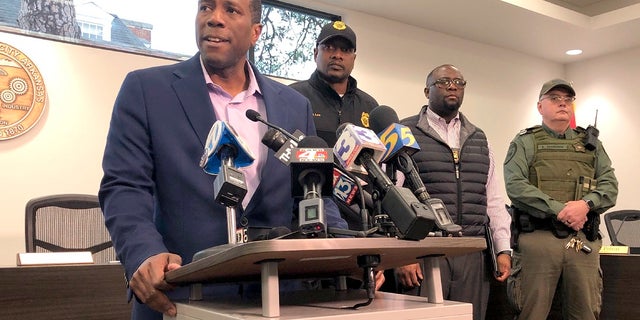 Forrest City, Ark., Mayor Cedric Williams, left, holding a news conference after two police officers were wounded and a gunman was killed in an exchange of gunfire at a Walmart in eastern Arkansas on Monday morning. (AP Photo/Adrian Sainz)