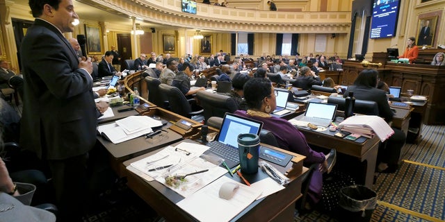 Del. Mark Levine, D-Alexandria, left, presents a bill during the floor session of the Virginia House of Delegates in Richmond.