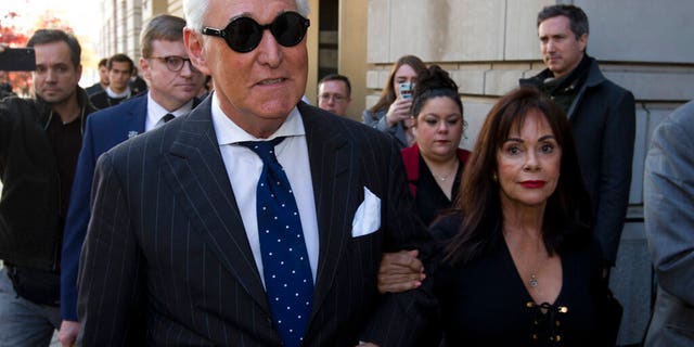 FILE - In this Nov. 15, 2019, file photo, Roger Stone, left, with his wife Nydia Stone, leaves federal court in Washington, Friday, Nov. 15, 2019. Federal prosecutors are asking a judge to sentence Stone to serve between 7 and 9 years in prison after his conviction on witness tampering and obstruction charges. (AP Photo/Jose Luis Magana, File)