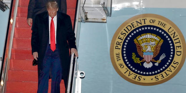 President Donald Trump walks down the stairs of Air Force One upon his arrival at Manchester-Boston Regional Airport, Monday, Feb. 10, 2020, in Manchester, N.H., for a campaign rally. (AP Photo/Steven Senne)