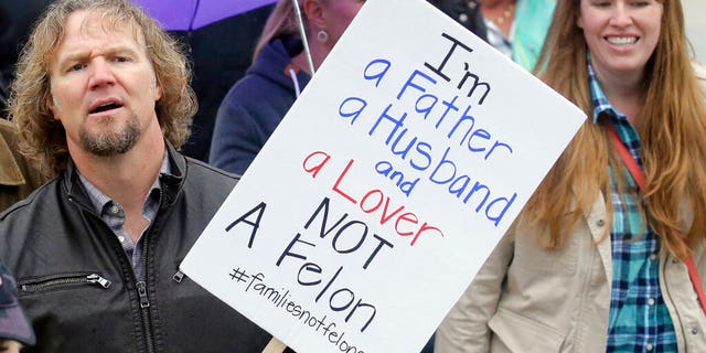 FILE: Kody Brown, left, from TV's reality show "Sister Wives," marches during a protest at the state Capitol, in Salt Lake City.