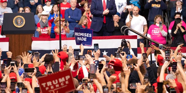 The audience cheers as President Donald Trump arrives on stage during a campaign rally, Monday, Feb. 10, 2020, in Manchester, N.H. (AP Photo/Mary Altaffer)