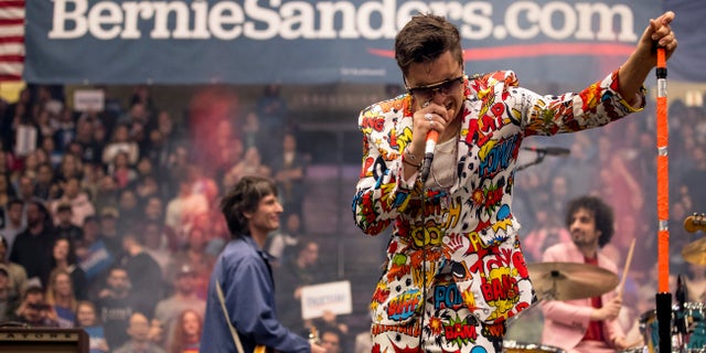 The Strokes performed "New York City Cops" with an officer on stage at a Bernie 2020 rally in Durham, N.H. (AP Photo/Andrew Harnik)