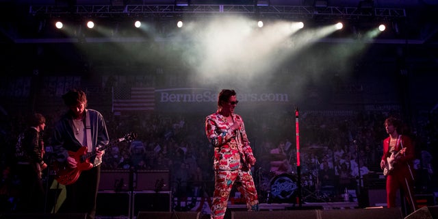 Julian Casablancas, lead singer of The Strokes, center, performs after Democratic presidential candidate Sen. Bernie Sanders, I-Vt., speaks at a campaign stop at the Whittemore Center Arena at the University of New Hampshire, Monday, Feb. 10, 2020, in Durham, N.H. (AP Photo/Andrew Harnik)