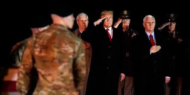 President Donald Trump and Vice President Mike Pence watch as a U.S. Army carry team moves a transfer case containing the remains of Sgt. 1st Class Javier Gutierrez, of San Antonio, Texas, Monday, Feb. 10, 2020, at Dover Air Force Base, Del. According to the Department of Defense both Gutierrez and Sgt. 1st Class Antonio Rodriguez, of Las Cruces, N.M., died Saturday, Feb. 8, during combat operations in Afghanistan. (AP Photo/Evan Vucci)