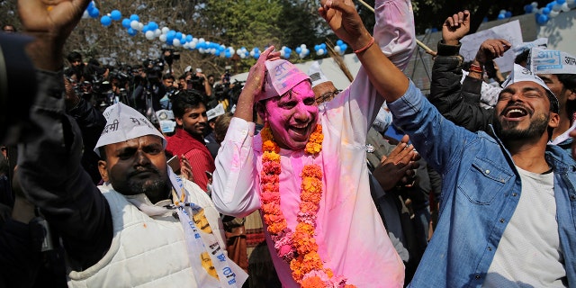 Supporters of the Aam Aadmi Party, or "common man's" party, celebrate the party's victory, at their party office in New Delhi, India, Tuesday, Feb. 11, 2020. Indian Prime Minister Narendra Modi’s Hindu nationalist party was facing a major defeat by the regional party Tuesday in elections in the national capital that were seen as a referendum on Modi's policies such as a new national citizenship law that excludes Muslims. (AP Photo/Altaf Qadri)