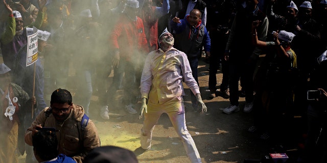 Supporters of the Aam Aadmi Party, or "common man's" party, celebrate the party's victory at their party office in New Delhi, India, Tuesday, Feb. 11, 2020. Indian Prime Minister Narendra Modi’s Hindu nationalist party was facing a major defeat by the regional party Tuesday in elections in the national capital that were seen as a referendum on Modi's policies such as a new national citizenship law that excludes Muslims. (AP Photo/Altaf Qadri)