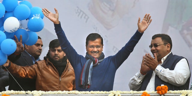 Incumbent Delhi Chief Minister Arvind Kejriwal, center, waves at Aam Aadmi Party, or "common man's" party headquarters as they celebrate the party's victory in New Delhi, India, Tuesday, Feb. 11, 2020. Indian Prime Minister Narendra Modi's Hindu nationalist party was facing a stunning defeat by a regional party Tuesday in elections in the national capital that were seen as a referendum on Modi's policies such as a new national citizenship law that excludes Muslims. (AP Photo/Manish Swarup)