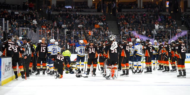Members of the St. Louis Blues and Anaheim Ducks gathering on the ice after Blues defenseman Jay Bouwmeester suffered a medical emergency.