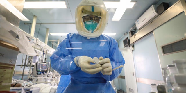 Medical staff work in the negative-pressure isolation ward in Jinyintan Hospital, designated for critical COVID-19 patients, in Wuhan in central China's Hubei province Thursday, Feb. 13, 2020. (Chinatopix Via AP)