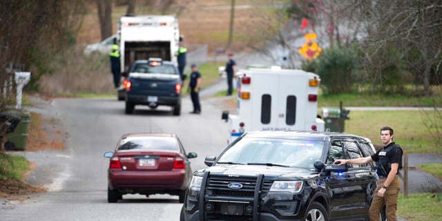 A Cayce police officer blocking an entrance to the Churchill Heights neighborhood Thursday in Cayce, S.C., where 6 year-old Faye Marie Swetlik vanished.