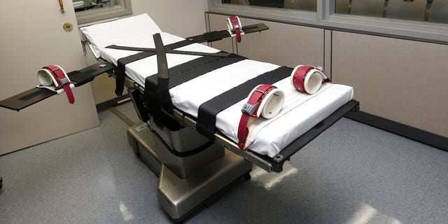 FILE - This Oct. 9, 2014, file photo shows the gurney in the the execution chamber at the Oklahoma State Penitentiary in McAlester, Okla. Oklahoma is planning to resume executing death-row inmates, five years after lethal injections were put on hold following a series of death-chamber mishaps, state officials announced Thursday, Feb. 13, 2020. (AP Photo/Sue Ogrocki, File)