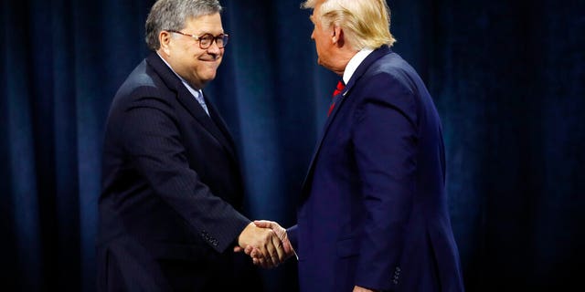 President Trump shakes hands with Attorney General Bill Barr last year. (AP Photo/Charles Rex Arbogast, File)