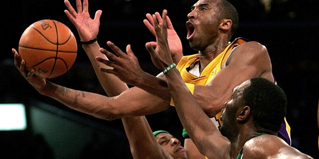 Los Angeles Lakers' Kobe Bryant, top, goes up for a shot between Boston Celtics' Paul Pierce, left, and Al Jefferson during the first half of an NBA basketball game in Los Angeles. (AP Photo/Branimir Kvartuc, File)