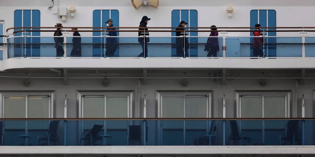 A group of quarantined passengers exercise on the Diamond Princess cruise ship Saturday, Feb. 15, 2020, in Yokohama, near Tokyo. A viral outbreak that began in China has infected more than 67,000 people globally. The World Health Organization has named the illness COVID-19, referring to its origin late last year and the coronavirus that causes it. (AP Photo/Jae C. Hong)