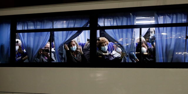 Buses carrying passengers from the quarantined Diamond Princess cruise ship leaving a port in Yokohama on Monday. (AP Photo/Jae C. Hong)