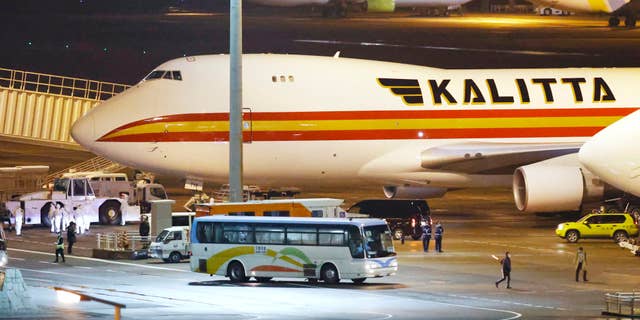 A bus carrying U.S. passengers who were aboard the quarantined cruise ship the Diamond Princess arriving at Haneda Airport in Tokyo. (Sadayuki Goto/Kyodo News via AP)