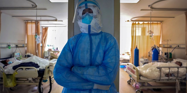 In this Sunday, Feb. 16, 2020, photo, a medical worker takes a nap at a hospital in Wuhan in central China's Hubei province. Chinese authorities on Monday reported a slight upturn in new virus cases and hundred more deaths for a total of thousands since the outbreak began two months ago. (Chinatopix via AP)