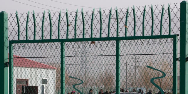 Residents line up inside the Artux City Vocational Skills Education Training Service Center which has previously been revealed by leaked documents to be a forced indoctrination camp at the Kunshan Industrial Park in Artux in western China's Xinjiang region.