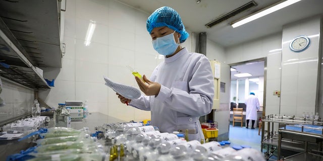 A nurse prepares medicines for patients at Jinyintan Hospital designated for new coronavirus infected patients, in Wuhan in central China's Hubei province. Blood supplies in several Chinese cities are reporting shortages amid travel restrictions that keep potential donors at home. (Chinatopix via AP)
