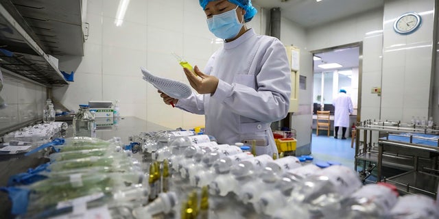 A nurse prepares medicines for patients at Jinyintan Hospital designated for new coronavirus infected patients, in Wuhan in central China's Hubei province. Blood supplies in several Chinese cities are reporting shortages amid travel restrictions that keep potential donors at home. (Chinatopix via AP)