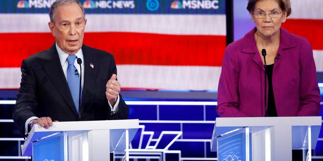 Democratic presidential candidates, former New York City Mayor Mike Bloomberg, left, speaks as Sen. Elizabeth Warren, D-Mass., looks on during a Democratic presidential primary debate Wednesday, Feb. 19, 2020, in Las Vegas, hosted by NBC News and MSNBC. (AP Photo/John Locher)