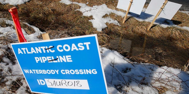 Signs that mark the route of the Atlantic Coast Pipeline in Deerfield, Va. The U.S. Supreme Court is set to wade into a long-running battle between developers of the 605-mile natural gas pipeline and environmental groups who oppose the pipeline crossing the storied Appalachian Trail. On Monday, Feb. 24, 2020, the high court will hear arguments on a critical permit needed by developers of the Atlantic Coast Pipeline. (AP Photo/Steve Helber)