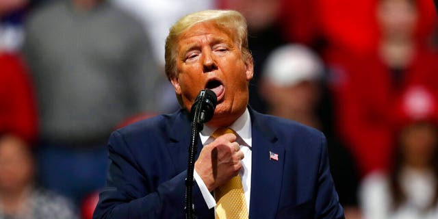 President Donald Trump acts as if he is choking to describe the Democratic debate performance of Michael Bloomberg as Trump speaks at a campaign rally Thursday, Feb. 20, 2020, in Colorado Springs, Colo. (AP Photo/David Zalubowski)