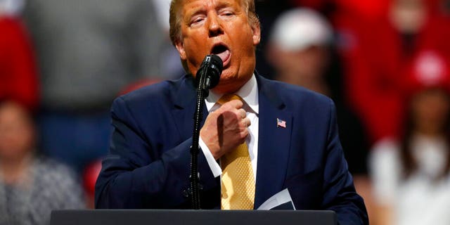 President Donald Trump acts as if he is choking to describe the Democratic debate performance of Michael Bloomberg as Trump speaks at a campaign rally Thursday, Feb. 20, 2020, in Colorado Springs, Colo. (AP Photo/David Zalubowski)